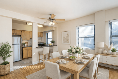 A dining room with a table set for a meal.