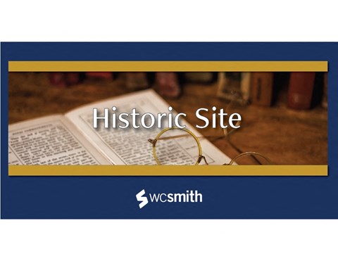 a history site with glasses on top of an open book