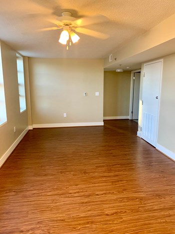 vacant living area with hardwood floorings, ceiling fan, and large windows at 3010 Pennsylvania Washington dc - Photo Gallery 8