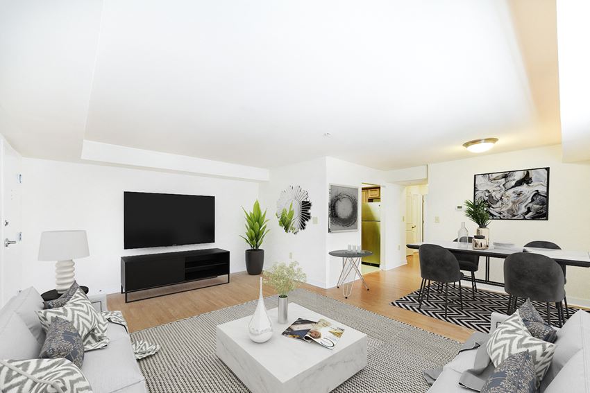 living area with sofa, coffee table, dining area, tv, and hardwood flooring at jasper place apartments in washington dc - Photo Gallery