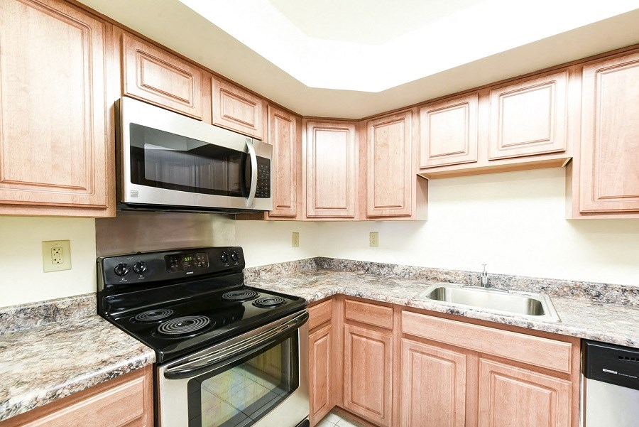 kitchen with stainless steel appliances and wood cabinetry at jasper place apartments in congress heights washington dc