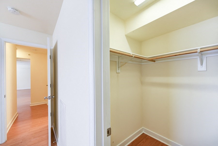 hallway view of walk in closet and living area with wood flooring at jasper place apartments in congress heights washington dc