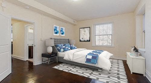 bedroom with bed, nightstands, dresser and large windows at juniper courts apartments in washington dc