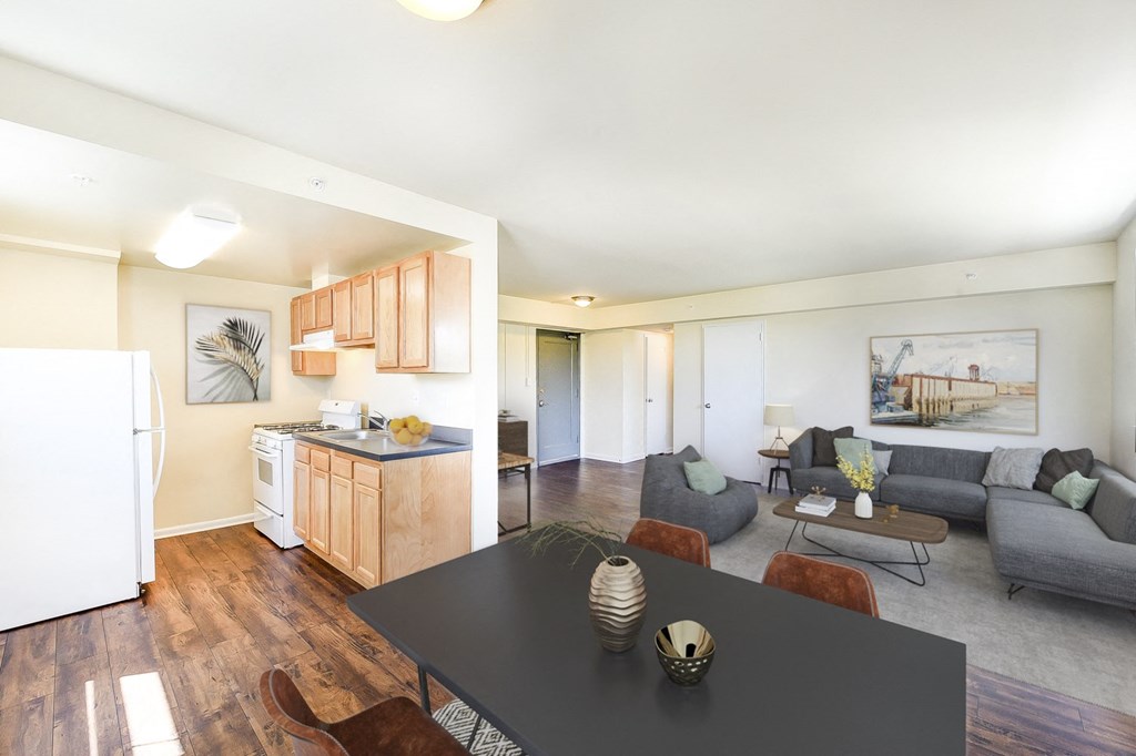a living room with a black dining table and a kitchen at 734 longfellow tax credit apartments in washington dc