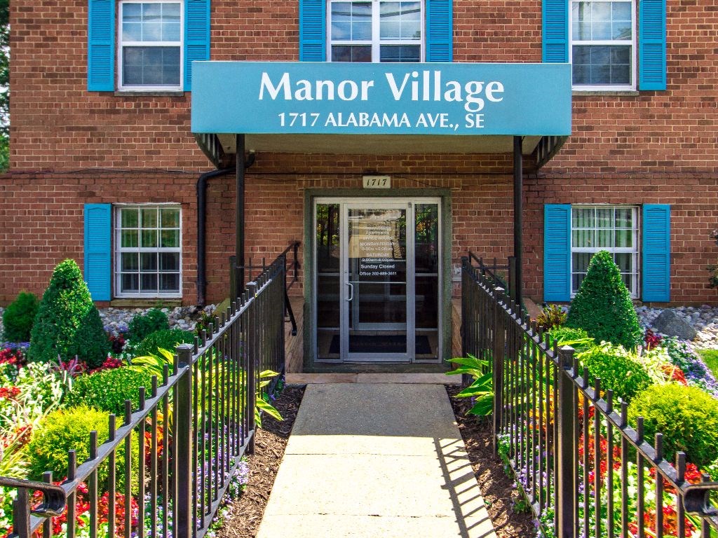 exterior of brick apartment building at manor village tax credit apartments in washington dc