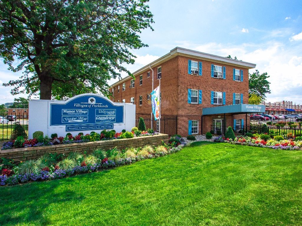 Villages of parklands monument sign next to manor village apartments in washington dc
