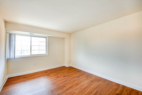 bedroom with window and wood flooring at naylor overlook apartments in skyland washington dc