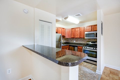 a kitchen with stainless steel appliances and granite counter tops