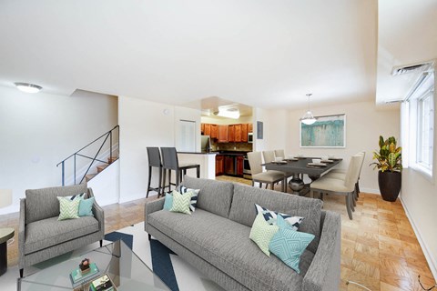 a living room with a couch and a table with chairs