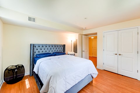 bedroom with bed, nightstand, large closet and view of bathroom at park vista apartments in washington dc
