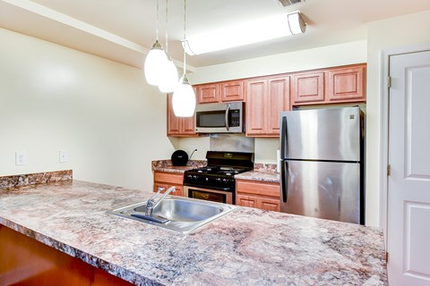 large kitchen with stainless steel appliances and large kitchen island at park vista apartments in washington dcl