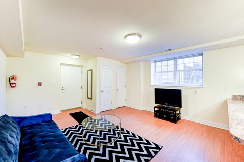 a living room with a blue couch and a tv