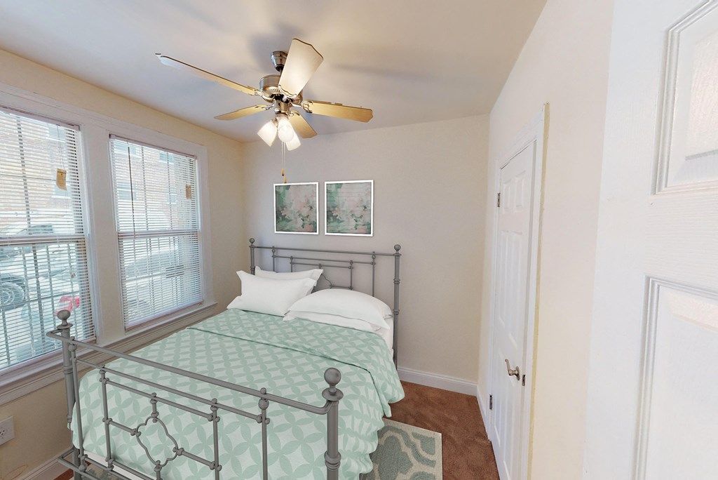 bedroom with bed, large windows, hardwood flooring and ceiling fan at parkside apartments in washington dc