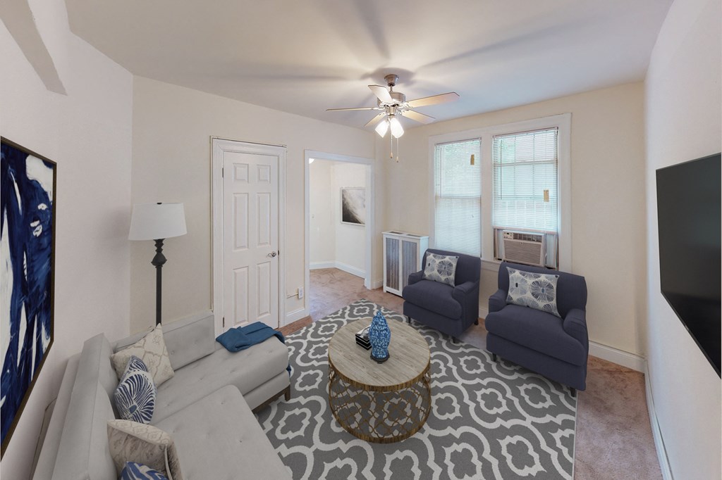 living area with large windows, sofa, coffee table, hardwood floors, and ceiling fan at parkside apartments in washington dc