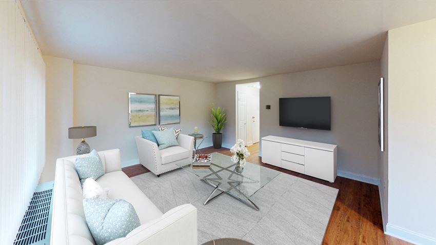 living area with sofa, coffee table, side chair, credenza and tv at penn view apartments in washington dc - Photo Gallery