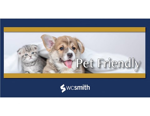 a dog and a cat sitting on a bed with the words pet friendly