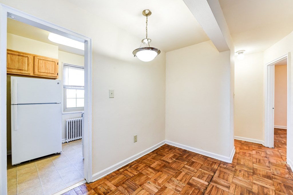 vacant living area with hardwood flooring and view of kitchen at richman apartments in washington dc