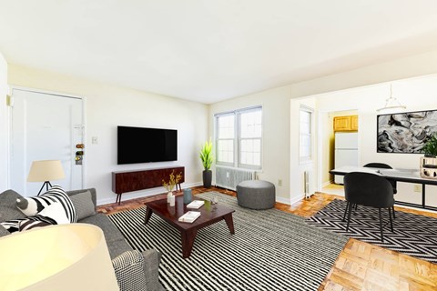 living area with sofa, coffee table, windows and view of dining area at the richman apartments in congress heights washington dc