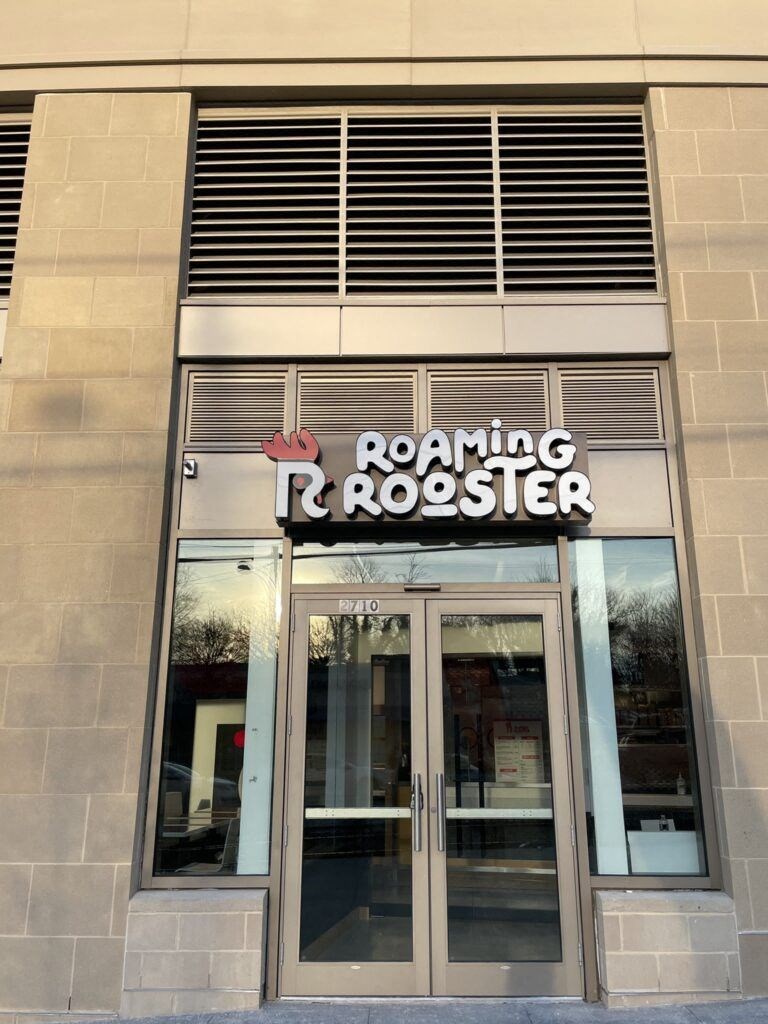 the front entrance of roaring roaster in the city