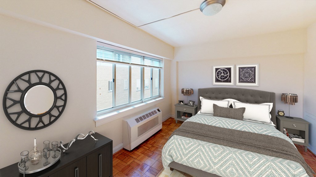 Bedroom with bed, nightstands, and large windows at sherry Hall apartments in washington dc