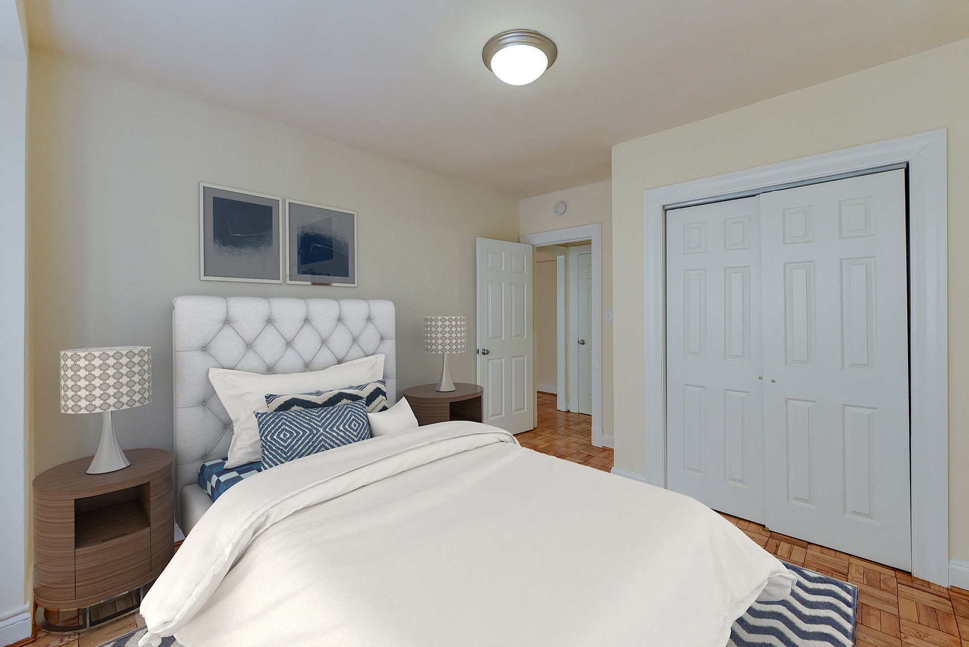 Bedroom with bed, nightstands, and large closet at sherry Hall apartments in washington dc
