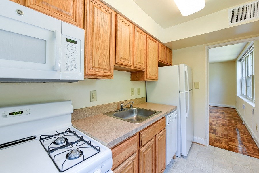 kitchen with gas range, refrigerator and view of dining area at shipley park apartments in shipley terrace washington dc