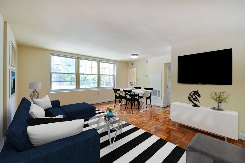living area with sofa, coffee table, credenza, tv , large windows and view of dining area at shipley park apartments in washington dc