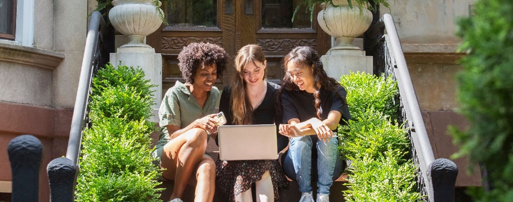 friends looking at computer outside