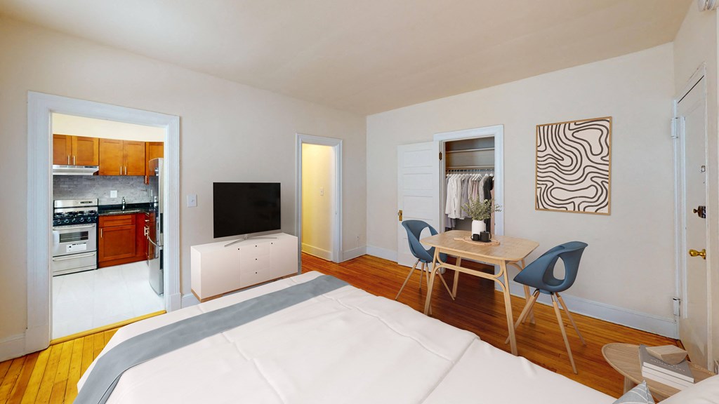 A modern bedroom with a large bed and a television.