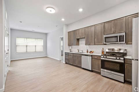 A kitchen with wooden cabinets and stainless steel appliances.