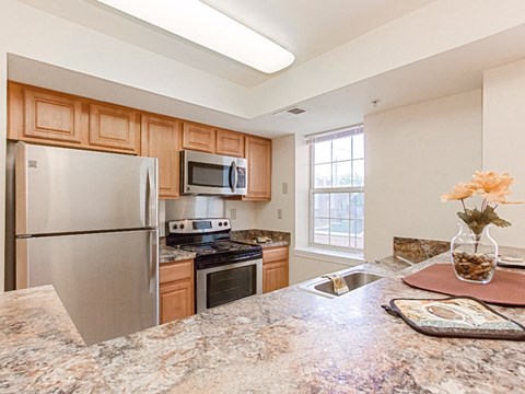 a kitchen with stainless steel appliances and granite counter tops