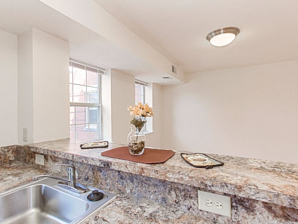 kitchen with breakfast bar and view of dining area at the oaks apartments in washington dc