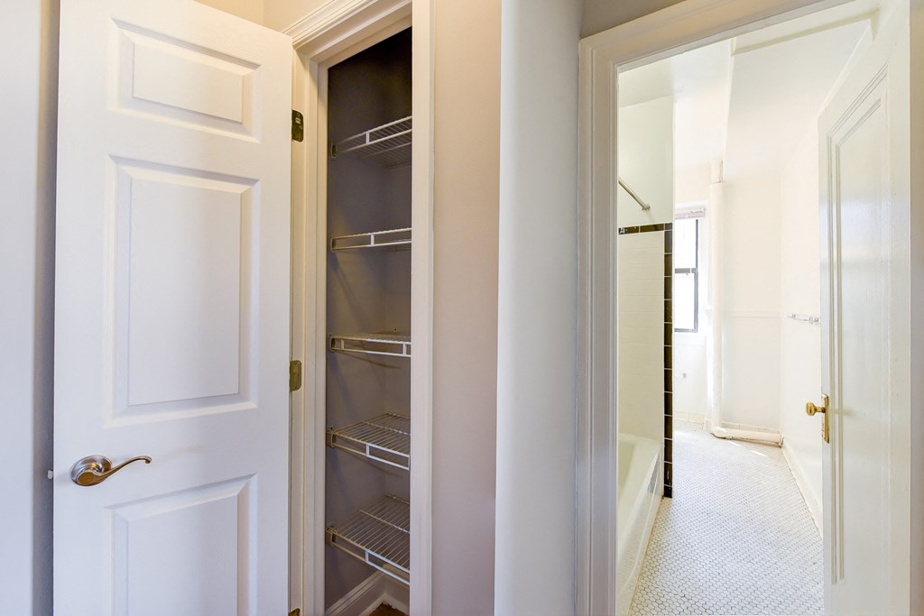 linen closet with shelving and view of bathroom at the shawmut apartments in adams morgan washington dc
