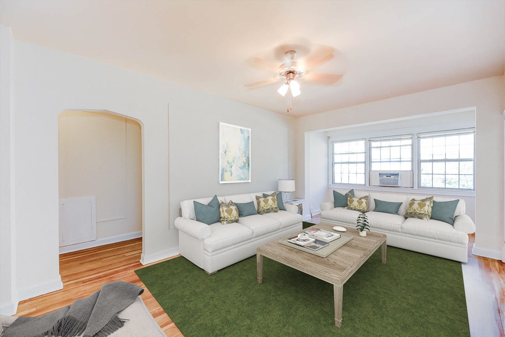 living area with sofa, coffee table, hardwood floors, ceiling fan and large windows at frontenac apartments in washington dc.