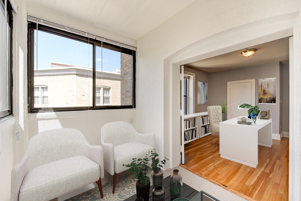 living area with seating, large windows and view of dining area at the shawmut apartments in washington dc