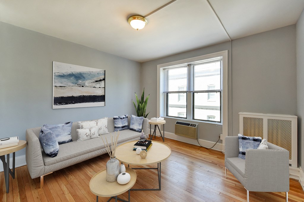living area with sofa, coffee table , hardwood floors and large windows at the shawmut in washington dc