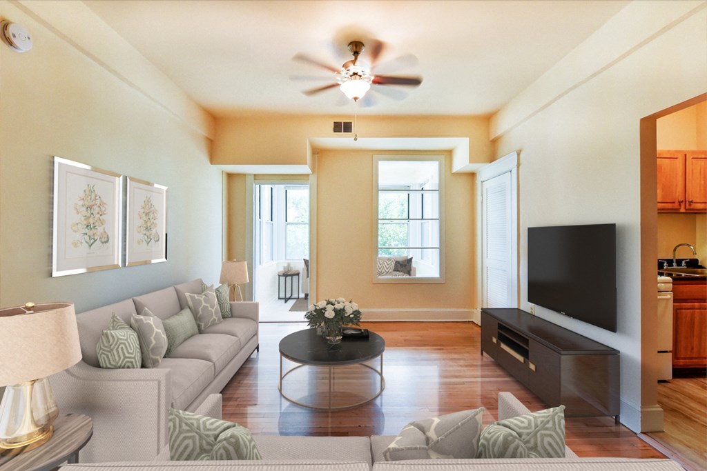 living area with large windows, sofa, coffee table, hardwood floors and view of kitchen at at twin oaks columbia heights washington dc