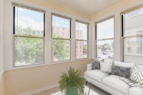 sunroom with sofa, coffee table and large windows at twin oaks columbia heights washington dc