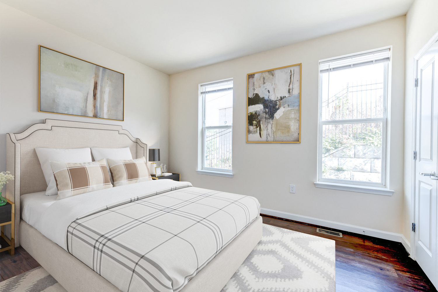 bedroom with bed, hardwood flooring and large windows at sheridan station south townhomes in washington dc