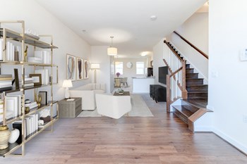 view of large living area with sofa, sitting area, bookshelves and staircase at sheridan station south townhomes in washington dc - Photo Gallery 5