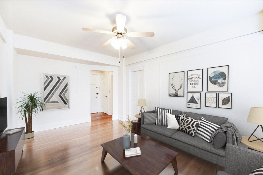 living area with sofa, coffee table, hardwood floors and ceiling fan at wakefield hall apartments in washington dc