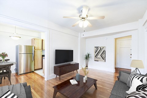 living area with sofa, coffee table, credenza, tv, hardwood floors, ceiling fan and view of kitchen at wakefield apartments in washington dc