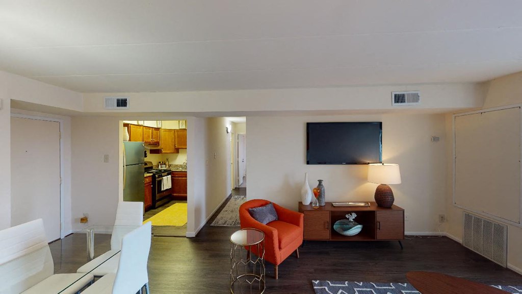 living room with credenza, tv, and view of dining area and kitchen at washington view apartments in southeast dc
