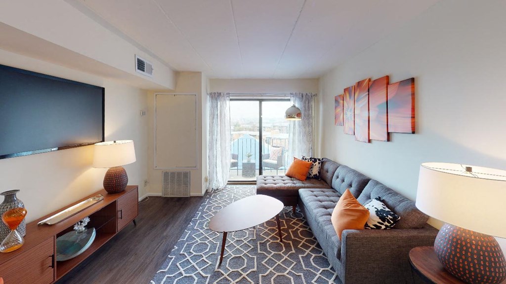 Livingroom with sofa, coffee table, decorative rug and view of balcony at washington view south east dc apartments