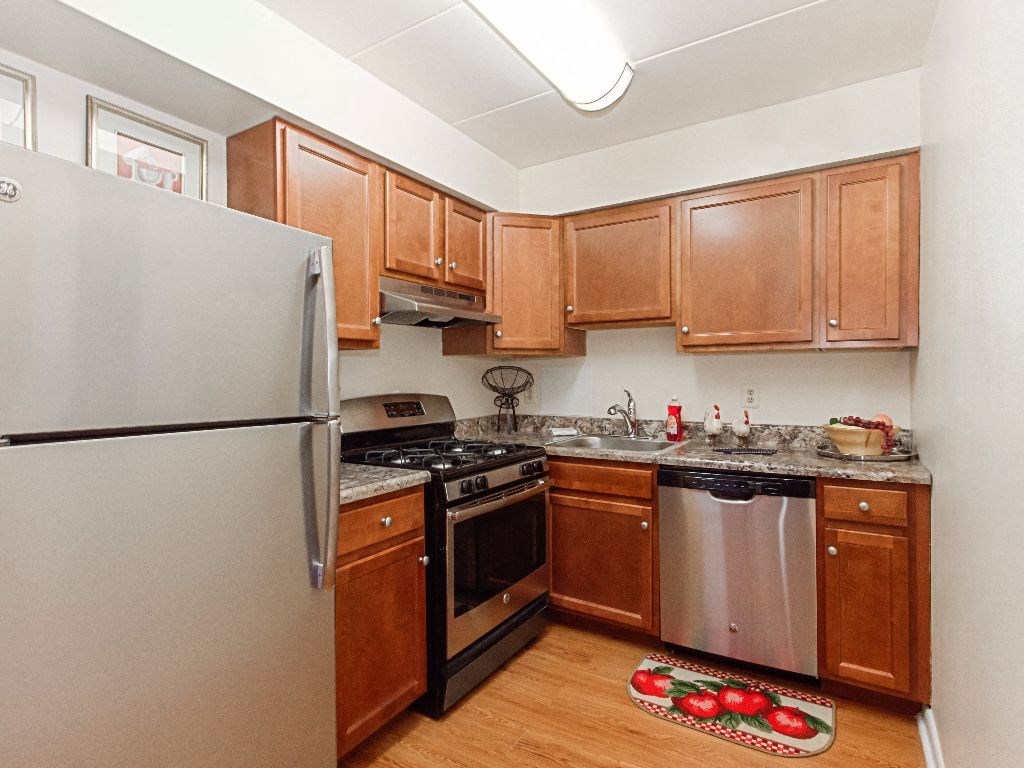 renovated kitchen with stainless steel appliances and hardwood flooring at washington view apartments in southeast dc