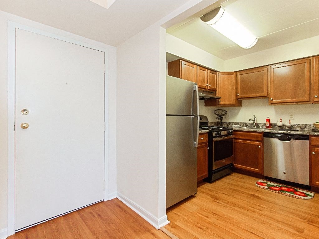 renovated kitchen with stainless steel appliances and hardwood flooring at washington view apartments in southeast dc