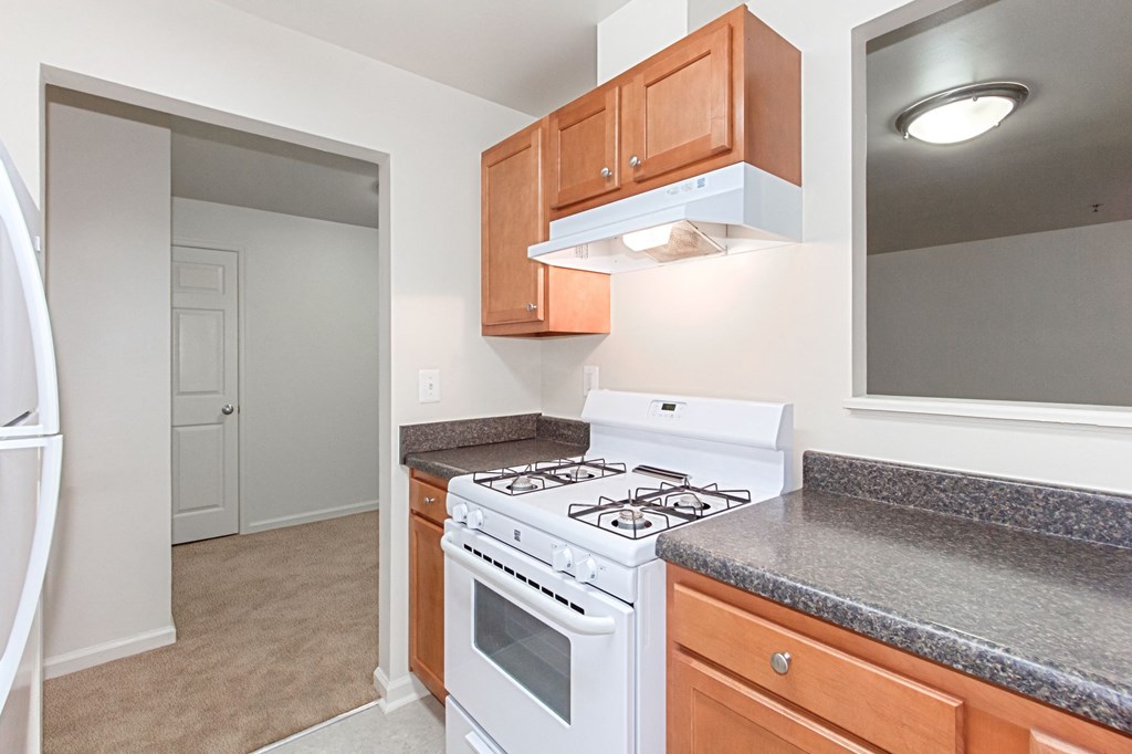 kitchen with gas range, wood cabinetry and energy efficient appliances at whitelaw apartments in washington dc