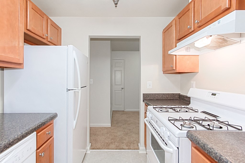 kitchen with gas range, wood cabinetry and energy efficient appliances at whitelaw apartments in washington dc