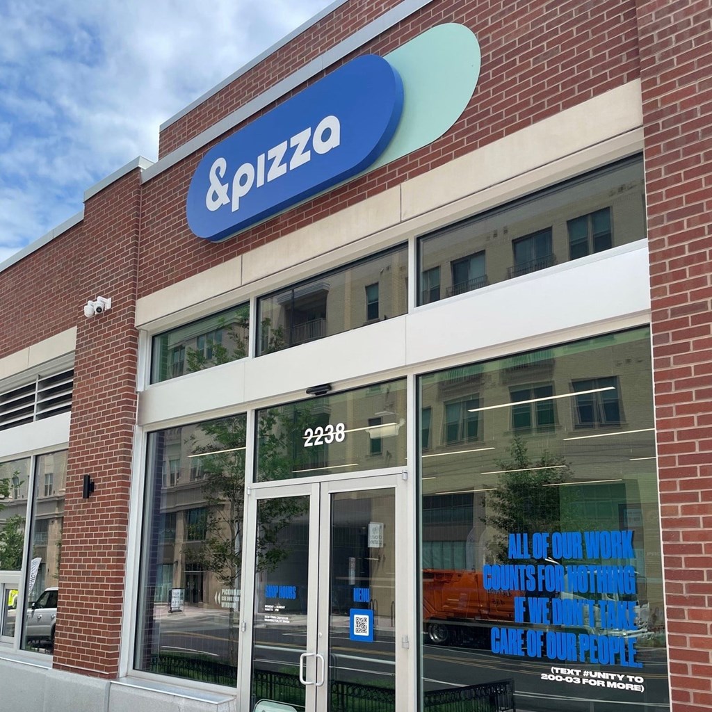 a building with a pizza company sign on top of it