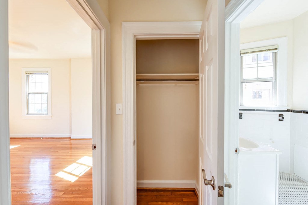 hallway view of closet, living area and bathroom at the frontenac apartments in van ness washington dc